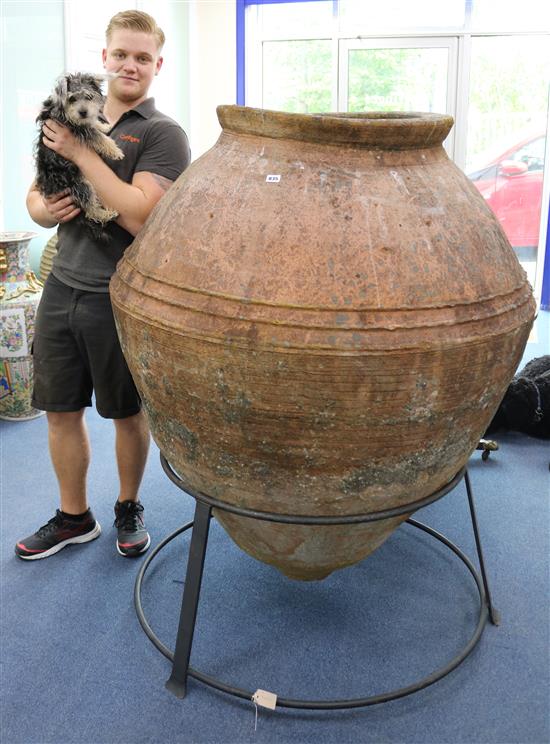 A large terracotta urn on wrought iron stand, H.155cm
